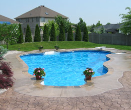 Lovely built in pool surrounded by decorative concrete pool deck.