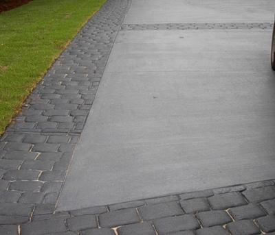 Gray, broom finished concrete driveway with stamped border.