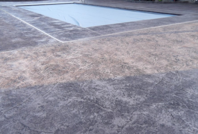 Gray colored in ground pool deck.