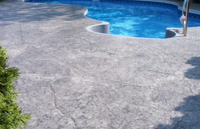 Light gray textured decorative pool deck.