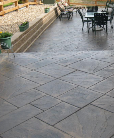 Stamped concrete front patio with brown stained color.