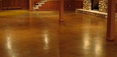 Interior basement floor of stained and polished concrete.