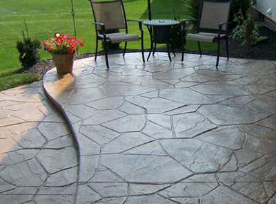 Stamped concrete patio designed to look like sand stone slates.