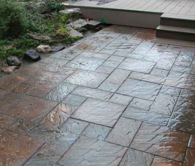 Front door patio designed as paver style stamped concrete.