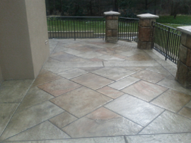 Wrap around front porch with stamped concrete floor.
