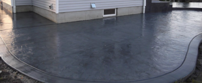 Dark gray stained concrete patio.