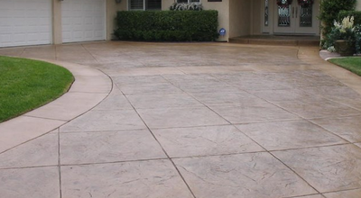 Stamped concrete driveway cut into large tile style squares.